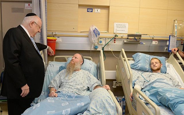 President Reuven Rivlin visits Rabbi Eitan Shnerb, whose daughter Rina was killed in a West Bank terror bombing, and his son Dvir at Hadassah Hospital Ein Kerem in Jerusalem on August 26, 2019. (Mark Neiman/GPO) President Reuven Rivlin visits Rabbi Eitan Shnerb, whose daughter Rina was killed in a West Bank terror bombing, and his son Dvir at Hadassah Hospital Ein Kerem in Jerusalem on August 26, 2019. (Mark Neiman/GPO)