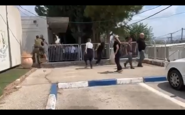 A scuffle breaks out outside the Samaria Military Court in the northern West Bank on August 7, 2019, after Amjad Na'alowa is convicted of failing to prevent his brother Ashraf's deadly terror attack in the Barkan Industrial Park last year. (Screenshot) A scuffle breaks out outside the Samaria Military Court in the northern West Bank on August 7, 2019, after Amjad Na'alowa is convicted of failing to prevent his brother Ashraf's deadly terror attack in the Barkan Industrial Park last year. (Screenshot)
