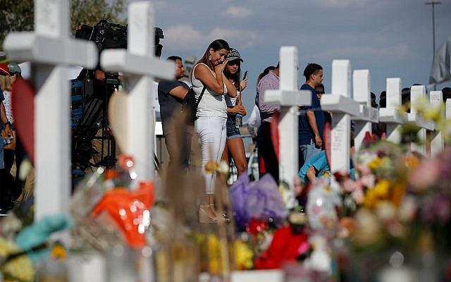 People visit a makeshift memoria at the site of a mass shooting in El Paso, Texas, August 5, 2019. (AP Photo/John Locher) People visit a makeshift memoria at the site of a mass shooting in El Paso, Texas, August 5, 2019. (AP Photo/John Locher)