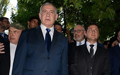 Prime Minister Benjamin Netanyahu, left, and Ukrainian President Volodymyr Zelensky, right, stand at Babi Yar ravine where Nazi troops murdered tens of thousands of Jews during WWII, in Kyiv, Ukraine, August 19, 2019. (AP Photo/Zoya Shu)