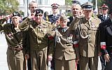 Polish officials and war veterans pay tribute to a World War II-era underground force that collaborated with Nazi German forces toward the end of the war in Warsaw, Poland, August 11, 2019. (AP Photo/Czarek Sokolowski)