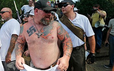 A white supremacist leaves Emancipation Park in Charlottesville, Virginia, August 12, 2017. (AP Photo/Steve Helber)