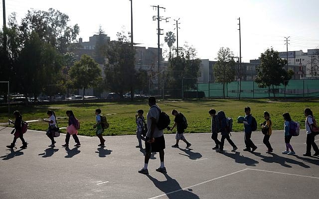 Illustrative: a group of students walk to their classroom at Kingsley Elementary School in Los Angeles, California, January 13, 2015. (AP Photo/Jae C. Hong) Illustrative: a group of students walk to their classroom at Kingsley Elementary School in Los Angeles, California, January 13, 2015. (AP Photo/Jae C. Hong)
