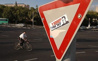 A man rides his bicycle near a poster demanding the release of Yigal Amir, the assassin of prime minister Yitzhak Rabin, in Jerusalem, November 2, 2006. (YOSSI ZAMIR/FLASH 90)