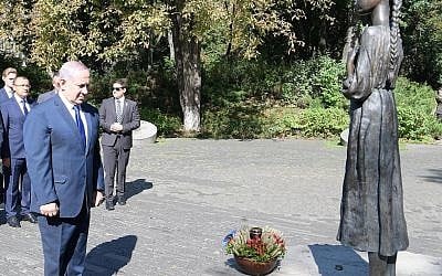 PM Netanyahu places a small wheat basket at a monument the victims of the Holodomor, a man-made famine that killed millions of Ukrainians and others, Kyiv, August 19, 2019 (Amos Ben Gershom/GPO)