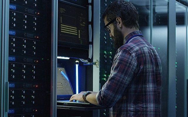 Illustrative: An IT worker stands in a server farm (Evgeniy Shkolenko; iStock by Getty Images) Illustrative: An IT worker stands in a server farm (Evgeniy Shkolenko; iStock by Getty Images)