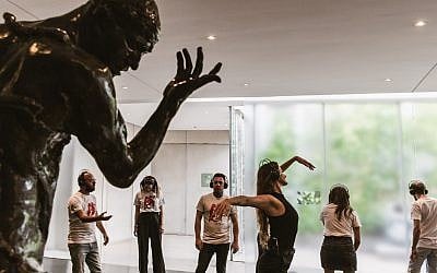 Actress Rona Lee Shim'on demonstrates to her audience how to move with a Rodin sculpture, in 'Moved by Art,' a new program at the Israel Museum (Courtesy Barak Aharon)