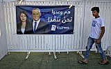 An Arabic-language campaign poster of Blue and White party leader Benny Gantz and MK Gadeer Mreeh is seen outside a campaign event in Shfaram on August 26, 2019. (Ahmad Gharabli/AFP)