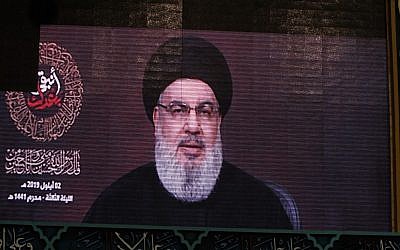 A speech by Hassan Nasrallah, the head of the Hezbollah terror group, is transmitted on a large screen in the Lebanese capital Beirut's southern suburbs on September 2, 2019. (AFP)