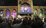Supporters of the Lebanese Shiite terror group Hezbollah react with clenched fists as they watch a speech by the movement's leader Hasan Nasrallah, transmitted on a large screen in the Lebanese capital Beirut's southern suburbs on September 2, 2019. (Photo by AFP)