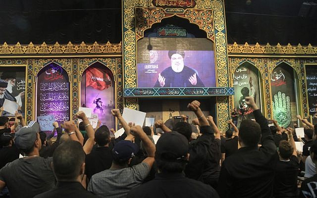 Supporters of the Lebanese Shiite terror group Hezbollah react with clenched fists as they watch a speech by the movement's leader Hasan Nasrallah, transmitted on a large screen in the Lebanese capital Beirut's southern suburbs on September 2, 2019. (Photo by AFP) Supporters of the Lebanese Shiite terror group Hezbollah react with clenched fists as they watch a speech by the movement's leader Hasan Nasrallah, transmitted on a large screen in the Lebanese capital Beirut's southern suburbs on September 2, 2019. (Photo by AFP)