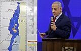Prime Minister Benjamin Netanyahu speaks before a map of the Jordan Valley, vowing to extend Israeli sovereignty there if reelected, during a speech in Ramat Gan on September 10, 2019. (Menahem Kahana/AFP)