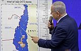 Prime Minister Benjamin Netanyahu points at a map of the Jordan Valley as he gives a statement, promising to extend Israeli sovereignty to the Jordan Valley and northern Dead Sea area, in Ramat Gan on September 10, 2019. (Menahem Kahana/AFP)