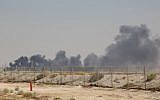 Smoke billows from an Aramco oil facility in Abqaiq about 60km (37 miles) southwest of Dhahran in Saudi Arabia's eastern province on September 14, 2019. (AFP)