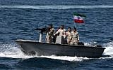 Iranian military personnel ride in a patrol boat as they take part in the 'National Persian Gulf Day' in the Strait of Hormuz. (ATTA KENARE / AFP/File)