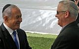 Prime Minister Benjamin Netanyahu (L) greets Benny Gantz, leader of Blue and White party, at a memorial ceremony for late Israeli president Shimon Peres, at Mount Herzl in Jerusalem on September 19, 2019. (GIL COHEN-MAGEN/AFP)