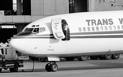 In this photo from June 19, 1985, two hijackers of TWA Flight 847 emerge from the plane at Beirut airport. (Nabil Ismail/AFP)