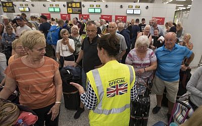 A British Government official speaks with passengers of the British travel group Thomas Cook at Son Sant Joan airport in Palma de Mallorca on September 23, 2019. (JAIME REINA / AFP)