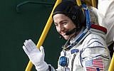 International Space Station (ISS) crew member, NASA's US astronaut Jessica Meir waves as she boards the Soyuz MS-15 spacecraft before its blasts off for the ISS, on September 25, 2019 at the Russian-leased Baikonur cosmodrome in Kazakhstan. (Maxim Shipenkov/Pool/AFP)