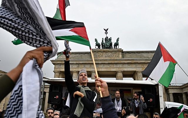 People wave Palestian flags at the Brandenburg Gate during a pro-Palestinian rally in Berlin on September 25, 2019. (Tobias Schwarz/AFP) People wave Palestian flags at the Brandenburg Gate during a pro-Palestinian rally in Berlin on September 25, 2019. (Tobias Schwarz/AFP)