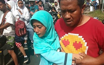 People gather outdoors at Batu Merah village in Ambon, Indonesia's Maluku islands, following a 6.5-magnitude earthquake on September 26, 2019. (YUSNITA/AFP)