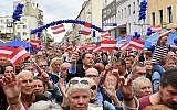 Supporters wave Austrian flags as they attend an election rally of the Austrian Freedom Party (FPOe) in Vienna, Austria on September 27, 2019. (JOE KLAMAR/AFP)