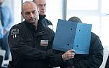 One of the defendants of the so-called "Revolution Chemnitz" is brought to the courtroom in Dresden, eastern Germany, on September 30, 2019, on the first day of the trial of an alleged neo-Nazi terrorist cell accused of plotting violent political upheaval in Germany. (Sebastian Kahnert/Pool/AFP)