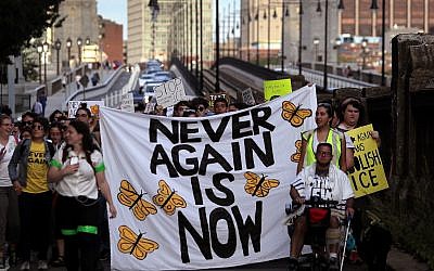 Jewish Never Again Action activists march across the Longfellow Bridge between Boston and Cambridge, Massachusetts, toward Amazon's Cambridge office after rallying at the New England Holocaust Memorial, September. 5, 2019. (Barry Chin/The Boston Globe via Getty Images via JTA)