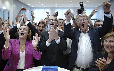 Chairman of right-wing party Alternative for Germany, AfD, Joerg Meuthen, second from right, top candidate Joerg Urban, center, top candidate for the Saxony state elections and board member Beatrix von Storch, left, react after first election results announced in Dresden, Germany, September 1, 2019. (Michael Kappeler/dpa via AP)