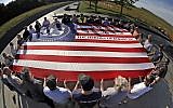 Visitors to the Flight 93 National Memorial in Shanksville, Pa., participate in a sunset memorial service on Tuesday, Sept. 10, 2019, as the nation prepares to mark the 18th anniversary of the Sept. 11, 2001 attacks. (AP Photo/Gene J. Puskar)