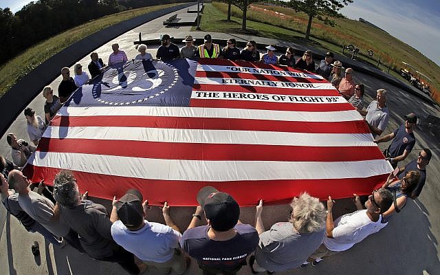 Visitors to the Flight 93 National Memorial in Shanksville, Pa., participate in a sunset memorial service on Tuesday, Sept. 10, 2019, as the nation prepares to mark the 18th anniversary of the Sept. 11, 2001 attacks. (AP Photo/Gene J. Puskar) Visitors to the Flight 93 National Memorial in Shanksville, Pa., participate in a sunset memorial service on Tuesday, Sept. 10, 2019, as the nation prepares to mark the 18th anniversary of the Sept. 11, 2001 attacks. (AP Photo/Gene J. Puskar)