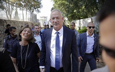 Blue and White party leader Benny Gantz and his wife Revital leave a polling station in Rosh Ha'ayin on election day, September 17, 2019. (AP Photo/Sebastian Scheiner)