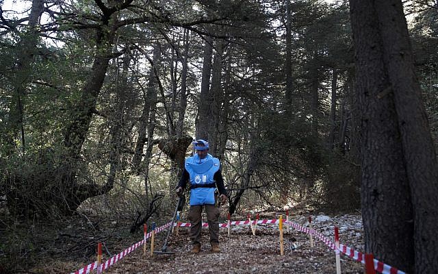 In this Sept. 18, 2019 photo, a Lebanese deminer from Humanity and Inclusion, a French-based international non-governmental organization, uses a mine detector at a cedar forest, in Hadath El-Jebbeh, north Lebanon (AP Photo/Hussein Malla) In this Sept. 18, 2019 photo, a Lebanese deminer from Humanity and Inclusion, a French-based international non-governmental organization, uses a mine detector at a cedar forest, in Hadath El-Jebbeh, north Lebanon (AP Photo/Hussein Malla)