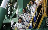 United Arab Emirates astronaut Hazzaa al Mansouri, centre, Russian cosmonaut Oleg Skripochka, bottom, and US astronaut Jessica Meir, top, members of the main crew to the International Space Station (ISS), board the Soyuz MS-15 spacecraft for the launch at the Russian leased Baikonur cosmodrome, Kazakhstan, September 25, 2019. (Maxim Shipenkov/Pool Photo via AP)