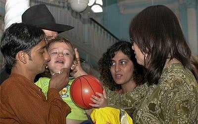 Moshe Holtzberg, 2-year-old orphan of the rabbi and his wife slain in the Mumbai Chabad House, is seen with his relatives at a synagogue in Mumbai, India, December 1, 2008. (AP Photo)