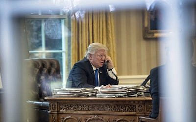 In this Jan. 28, 2017, file photo, President Donald Trump speaks on the phone with German Chancellor Angela Merkel in the Oval Office at the White House in Washington. (AP Photo/Andrew Harnik, )