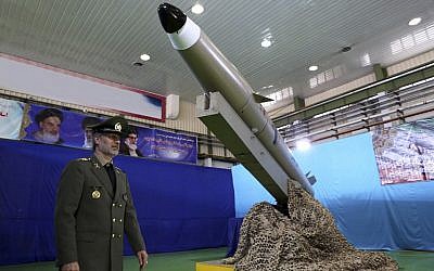 In this picture released by the official website of the Iranian Defense Ministry on August 13, 2018, Defense Minister Gen. Amir Hatami walks past a Fateh-e Mobin (Bright Conqueror) missile during inauguration of its production line at an undisclosed location, Iran. (Iranian Defense Ministry via AP)