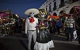 Performers in costume attend a Day of the Dead parade in Juchitan, Mexico, October 31, 2018 (AP Photo/Rodrigo Abd)