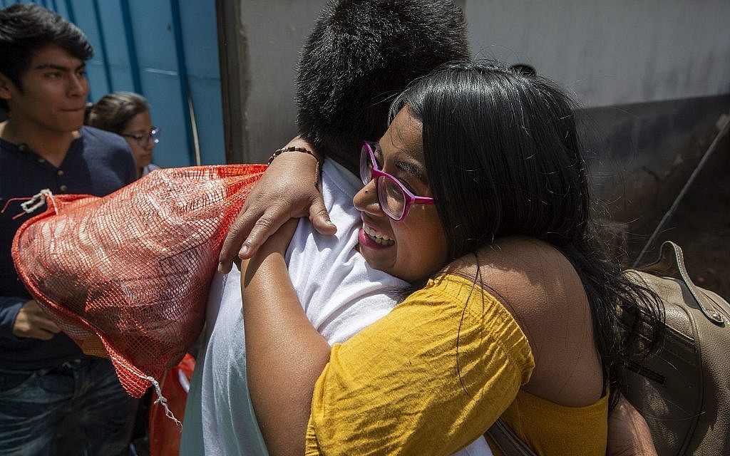 Illustrative: A woman embraces a Guatemalan migrant who was deported from the United States, after arriving at the Air Force Base in Guatemala City, Tuesday, July 16, 2019. (AP Photo/Moises Castillo) Illustrative: A woman embraces a Guatemalan migrant who was deported from the United States, after arriving at the Air Force Base in Guatemala City, Tuesday, July 16, 2019. (AP Photo/Moises Castillo)