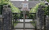 A gate protects the entrance of the Rooksnest estate near Lambourn, England, Tuesday, Aug. 6, 2019. The manor is the domain of Theresa Sackler, widow of one of Purdue Pharma’s founders and, until 2018, a member of the company’s board of directors. A complex web of companies and trusts are controlled by the family, and an examination reveals links between far-flung holdings, far removed from the opioid manufacturer’s headquarters in Stamford, Conn. (AP Photo/Frank Augstein)