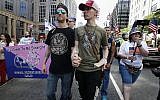 Peter Brown, center left, and Mark Hutt, center right, who said they are engaged to be married, hold hands as they march with others in the Straight Pride Parade in Boston, Saturday, August 31, 2019. (AP Photo/Michael Dwyer)