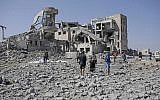Bodies covered in plastic lie on the ground amid the rubble of a Houthi detention center destroyed by Saudi-led airstrikes, that killed at least 60 people and wounded several dozen according to officials and the rebels' health ministry, in Dhamar province, southwestern Yemen, Sept. 1, 2019 (AP Photo/Hani Mohammed)