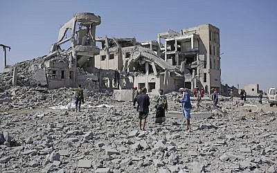 Bodies covered in plastic lie on the ground amid the rubble of a Houthi detention center destroyed by Saudi-led airstrikes, that killed at least 60 people and wounded several dozen according to officials and the rebels' health ministry, in Dhamar province, southwestern Yemen, Sept. 1, 2019 (AP Photo/Hani Mohammed)