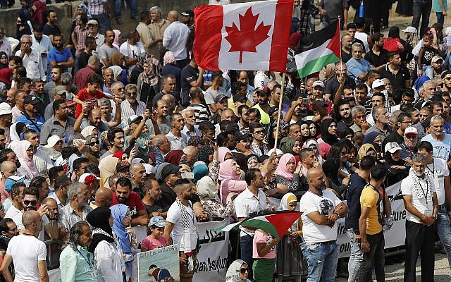 Hundreds of Palestinian refugees waving Palestinian and Canadian flags request asylum at a rally outside the Canadian Embassy, in Beirut, Lebanon, September 5, 2019. (AP Photo/Hussein Malla) Hundreds of Palestinian refugees waving Palestinian and Canadian flags request asylum at a rally outside the Canadian Embassy, in Beirut, Lebanon, September 5, 2019. (AP Photo/Hussein Malla)