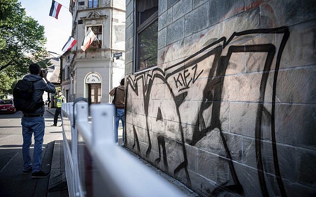 'Nazi-Kiez' sprayed on a wall, opposite a house on which imperial flags hang out of the windows in Dortmund' Germany, Sept.6, 2019 (Fabian Strauch/dpa via AP)