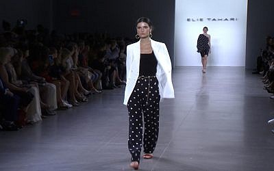 This Sept. 5, 2019 image taken from video shows a model wearing fashion from the Elie Tahari Spring/Summer 2020 collection during Fashion Week in New York. (AP Photo/Mark Cohen)