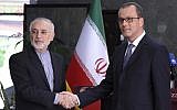 In this photo released by the Atomic Energy Organization of Iran, the head of the organization Ali Akbar Salehi, left, shakes hands with Acting Director General of the International Atomic Energy Agency, IAEA, Cornel Feruta during their meeting in Tehran, Iran, September 8, 2019. (Atomic Energy Organization of Iran via AP)