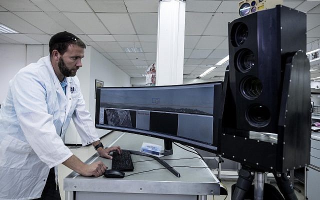 Ariel Gomez, a systems engineer at Israel Aerospace Industries, works on the Popstar system at Israel Aerospace Industries, in the town of Yehud, September 9, 2019. (AP Photo/Tsafrir Abayov)