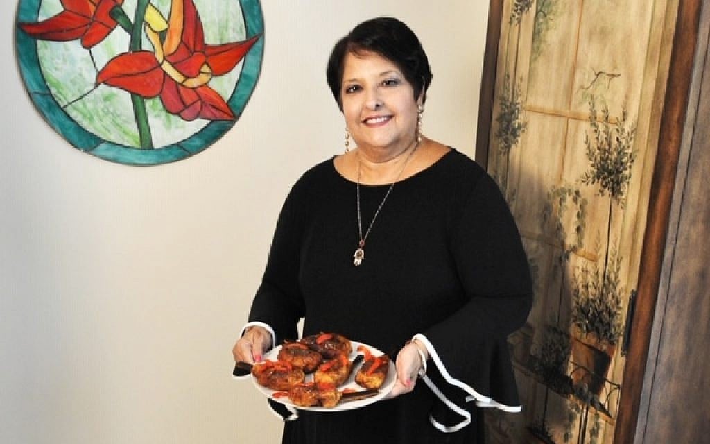 Genie Milgrom holding a plate of Chuletas. (Courtesy of Genie Milgrom)
