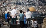 Tourists look at the view of the Dome of the Rock and the Temple Mount from the lookout of the Mount of Olives overlooking the Old City of Jerusalem, on October 11, 2018. (Hadas Parush/Flash90)